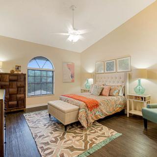 A beautifully decorated bedroom with a comfortable bed, stylish furniture, and elegant lighting.