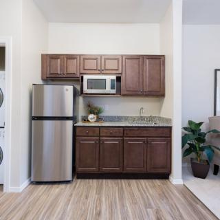 Compact kitchen area with wooden cabinets and modern appliances.