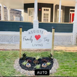 A welcoming sign promoting family living in a beautifully landscaped setting.