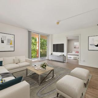 A modern and minimalist living room featuring natural light and stylish furniture.