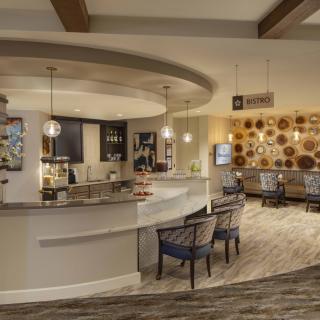 A modern lounge area with a bar and stylish seating.