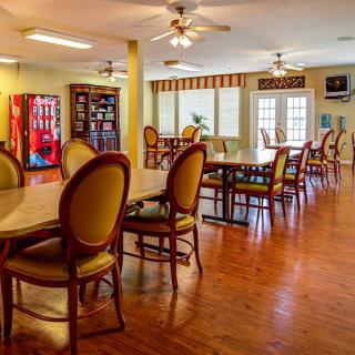 An inviting dining area with tables, chairs, and a vending machine.