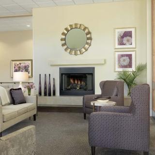 A cozy and inviting living room featuring a modern fireplace, elegant seating, and tasteful decor.