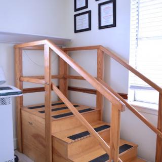 A wooden staircase with handrails, commonly used for rehabilitation exercises.