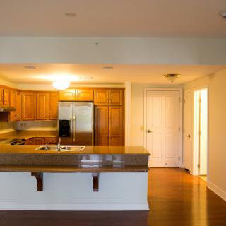 Modern kitchen with wooden cabinets and stainless steel appliances.