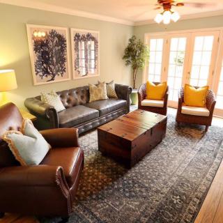 A cozy living room with comfortable seating, a central coffee table, and elegant decor.