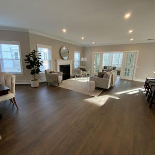 A beautifully designed modern living room filled with natural light and stylish furniture.