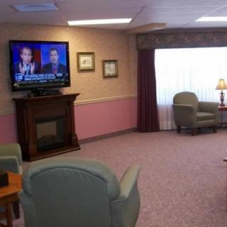 A cozy living room with a television and comfortable seating.