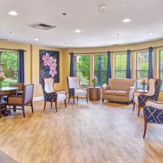 A cozy living room with comfortable seating and large windows letting in natural light.