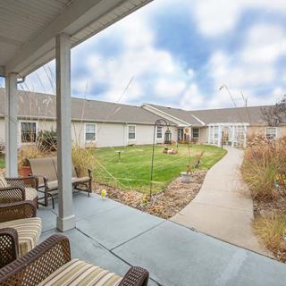 A peaceful courtyard with a patio, garden, and outdoor seating area.