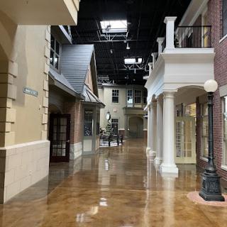 A view of an indoor shopping area featuring a blend of modern and classic architectural styles.
