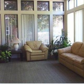 A cozy living room with comfortable seating and ample natural light.
