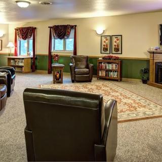 A cozy living room with comfortable seating, a television, and homey decor.