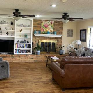 A cozy living room featuring a warm atmosphere with comfortable seating and decorative elements.