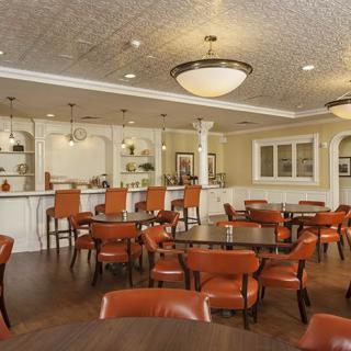 A spacious restaurant interior with a bar area and multiple seating arrangements.