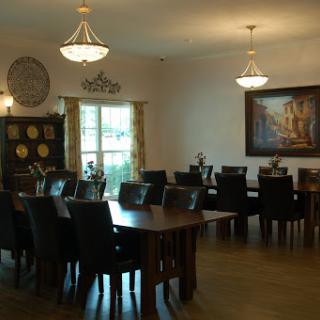 A spacious dining room featuring elegant furniture and ambient lighting.