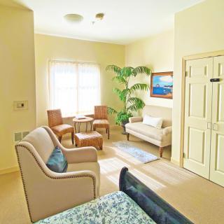 A cozy and well-lit living room with comfortable seating and tasteful decor.