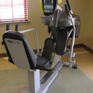 An elliptical exercise machine in a gym setting.