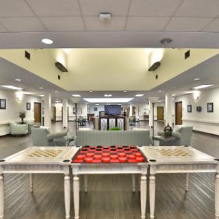A spacious recreational lounge featuring game tables for checkers, designed for relaxation and social interaction.