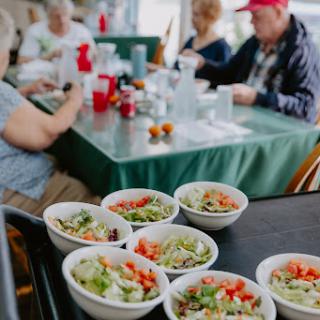 A vibrant spread of fresh salads served at a communal dining table.