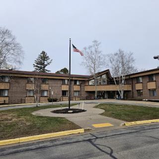 A view of a residential building with an American flag in front.