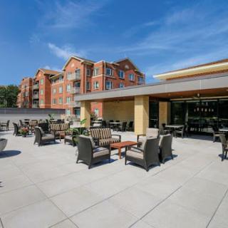 A modern outdoor patio area with comfortable seating on a sunny day.