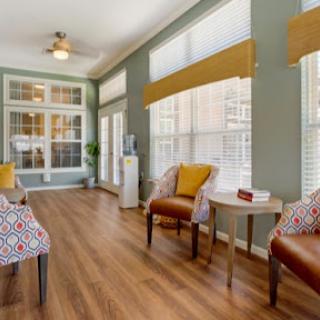 A bright and inviting living room featuring comfortable seating and warm wooden flooring.
