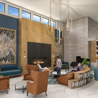 A modern lobby with stylish furniture, a central fireplace, and elegant lighting.