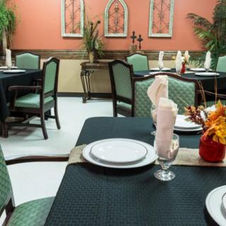 Elegantly set dining area with neatly arranged tables and chairs.