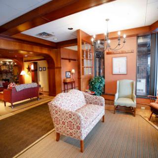 A cozy living room with elegant furniture and warm wooden accents.