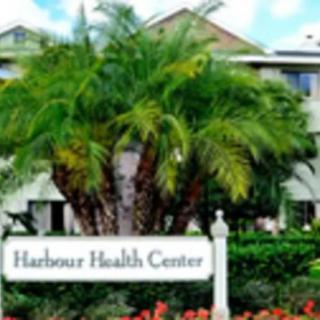 A health center surrounded by palm trees and landscaped gardens.