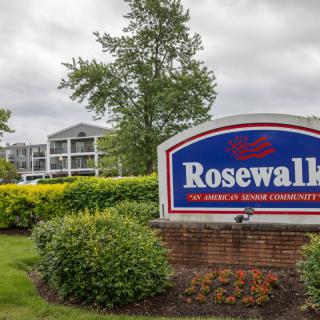 Entrance sign of the Rosewall retirement community with landscaped greenery and residential buildings in the background.