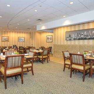 An empty restaurant dining area with neatly arranged tables and chairs.