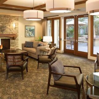 A cozy and modern living room with comfortable seating and a fireplace.