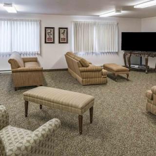 A cozy living room with comfortable seating and a large TV.