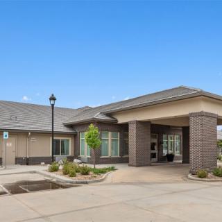 A modern building with a welcoming entrance and landscaped surroundings.