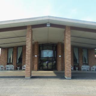 A modern brick building featuring a welcoming entrance and outdoor seating.