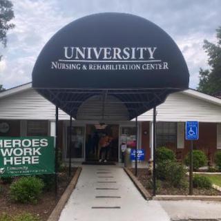 Entrance to the University Nursing and Rehabilitation Center, highlighting the dedicated staff with a 'Heroes Work Here' sign.