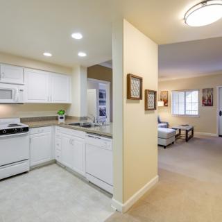A cozy open layout apartment featuring a modern kitchen and a comfortable living room.
