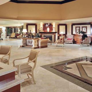 A luxurious hotel lobby featuring elegant furniture and ambient lighting.