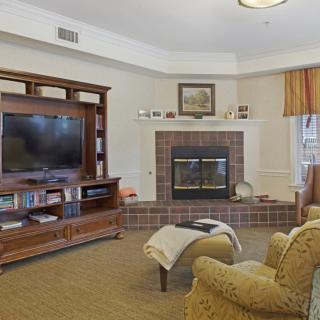 Cozy living room with a fireplace, television, and comfortable seating.