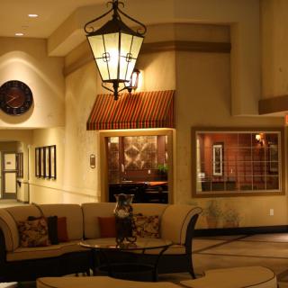 A warmly lit lobby with comfortable seating and elegant decor.