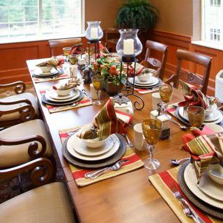 A beautifully set dining table with elegant tableware and decorations.