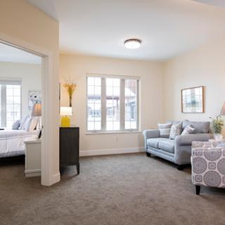 A cozy living room featuring a comfortable sofa and large windows that let in natural light.