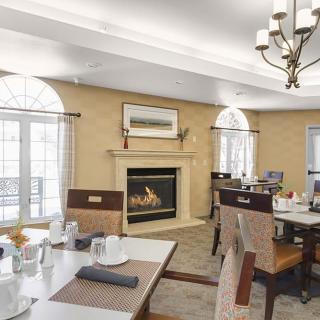 A cozy dining room featuring a fireplace and elegant seating arrangement.