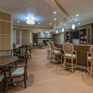 A cozy dining and bar area with elegant lighting and classic furniture.