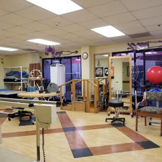 A well-equipped physical therapy room featuring various exercise and rehabilitation tools.
