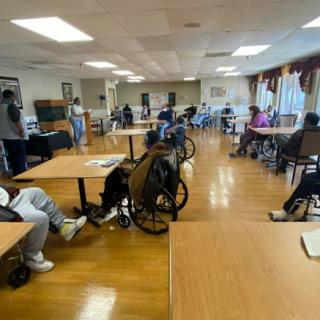 Elderly individuals engaging in activities at a community center.