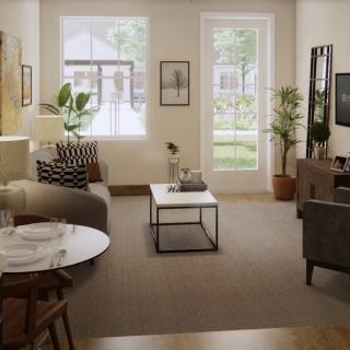 A cozy living room with modern decor, featuring a sofa, coffee table, and abundant natural light.