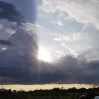 A beautiful display of sunlight breaking through the clouds, illuminating the sky.